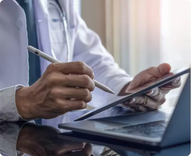 Physician reviewing reports on a tablet